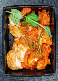 chicken fillet with a side of stewed vegetables