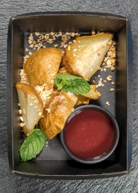 baked pear with berry sauce and nuts