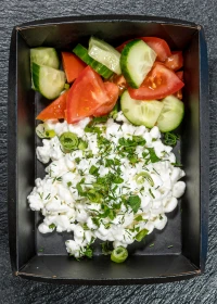 cottage cheese and cheese appetizer with a mix of fresh vegetables