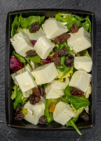 salad with spinach, arugula, dried fruits and cheese